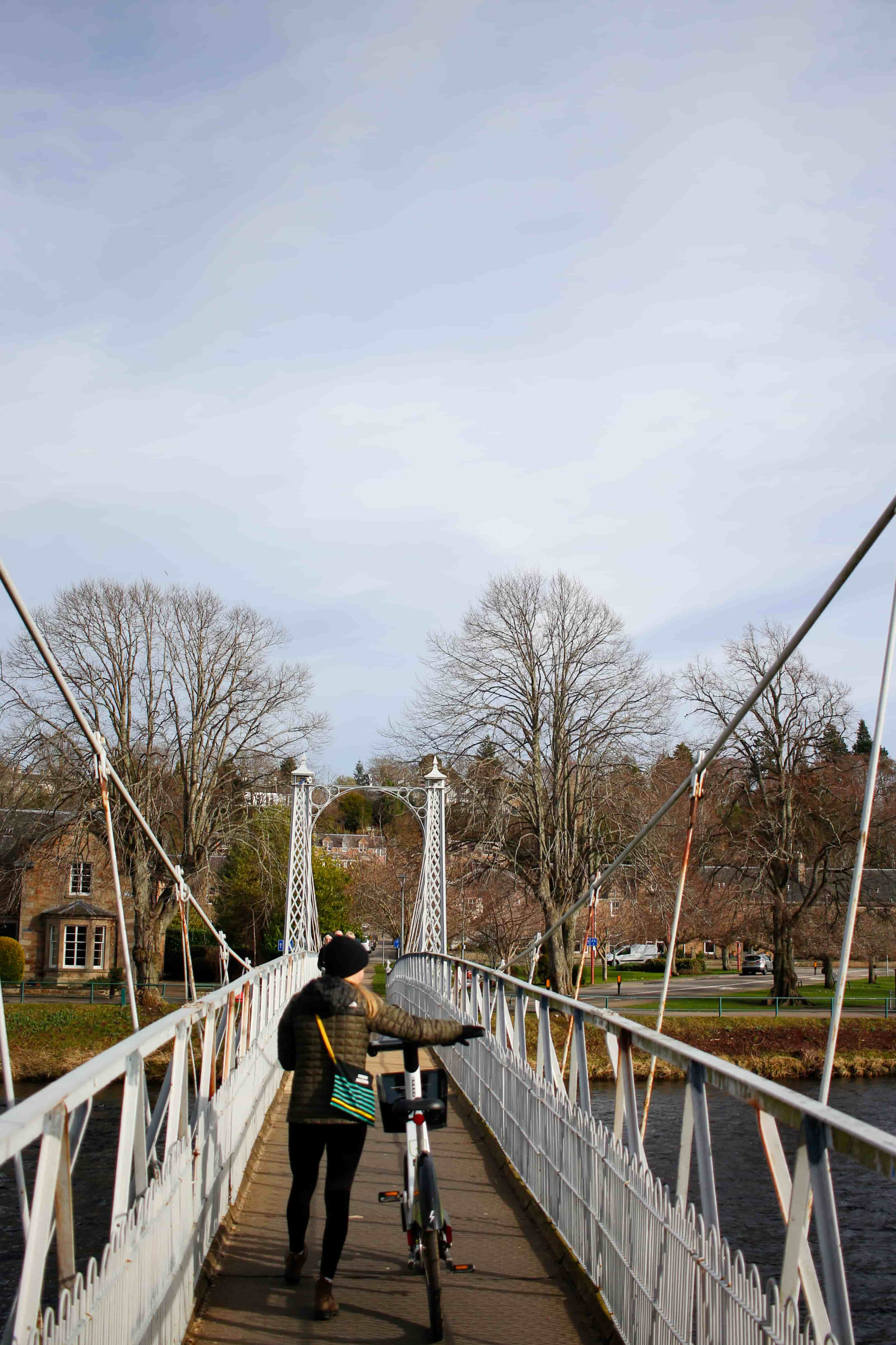 person on a bridge with a bike 