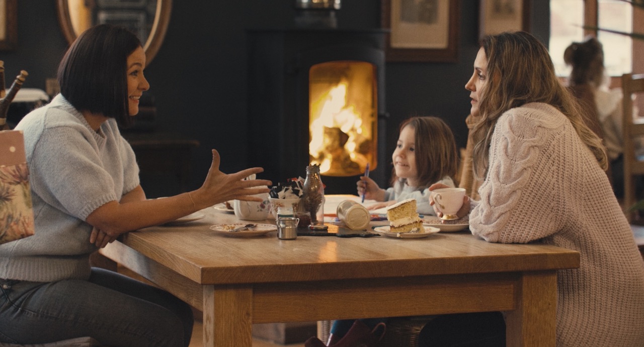 people enjoying drinks next to a fire