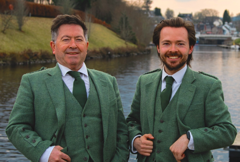 The owners of Highland Tour company stood by a canal 
