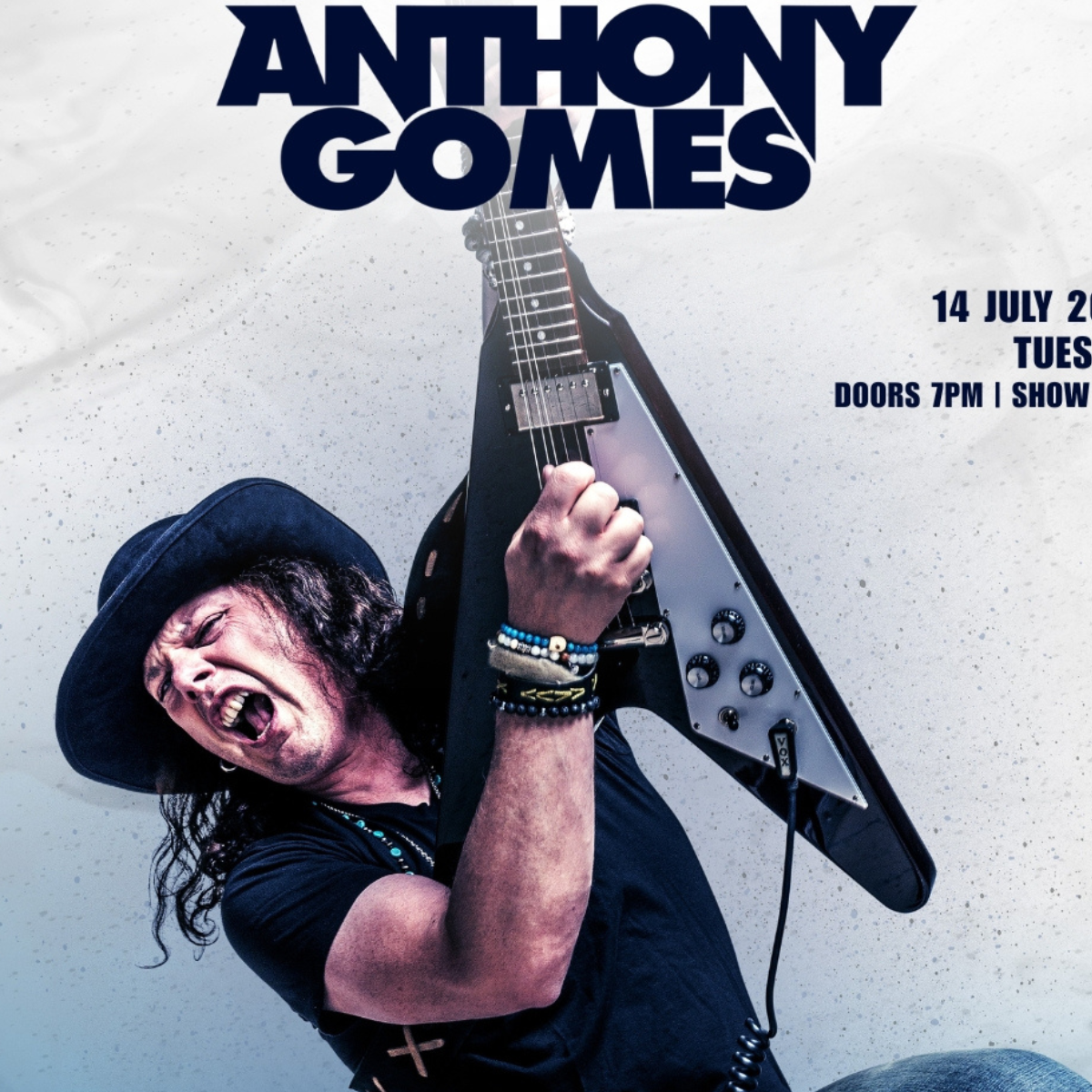 Anthony Gomes performing with a triangular guitar